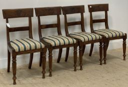 A set of four William IV mahogany dining chairs, the well figured crest rail above a bar back and