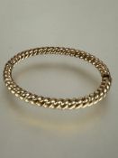 A 9ct gold spiral rope pattern hinged bangle with invisible clip fastening no signs of hard solder