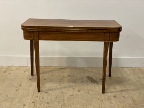 A George III mahogany fold over tea table, the top edge, frieze and square tapered supports with