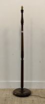 A 1930's turned and stained hardwood standard lamp. H158cm.