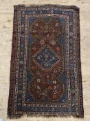 A South east Persian / Baluchi antique hand knotted rug, of all over stylised floral and geometric