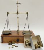 An antique set of brass weighing scales (class B 2oz) mounted on wooden base with single drawer,