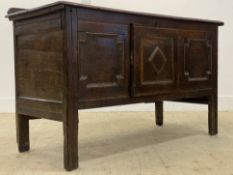 A 17th century and later oak sideboard, the top with ledge back over geometric panelled front with