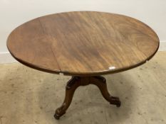 A Victorian mahogany circular tilt top and drop leaf dining table, on a baluster turned column and
