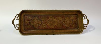 A 20thc Eastern style decorated brass serving tray with twin handles and etched floral decoration to