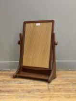 A mid 20th century walnut framed vanity mirror, the rectangular plate swivelling between two