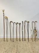 A collection of five vintage walking sticks, including some with white metal or silver mounts etc...