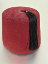 Property of the late Countess Haig, a 1920s red felt covered Fez with rush lined interior and