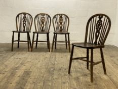 A set of four early 20th century country elm and ash Windsor dining chairs, each with hoop,