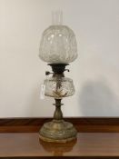 An Edwardian brass oil lamp in the Neoclassical taste, complete with etched and floral moulded glass