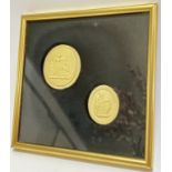 Two low/bas-relief carved wax medallions depicting classical scenes, housed in a glazed and gilt