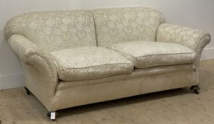 A Victorian two seat sofa, with undulating back and out-swept arms raised on compressed bun front