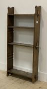 An early 20th century oak three height bookcase, (clothes pegs used for shelves) H120cm, W54cm.