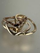 A three colour metal four ring puzzle ring Q 7.23g