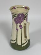 A Edwardian Mintons pottery ewer of flared design with floral and leaf in the Art Nouveau taste no