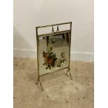 An Edwardian brass fire screen, inset with a floral painted bevelled mirror. H73cm.