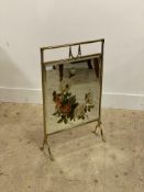 An Edwardian brass fire screen, inset with a floral painted bevelled mirror. H73cm.