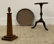 An Edwardian mahogany wine table with circular dished top on a turned column and triple splay