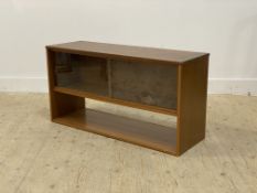 A mid century teak veneered side cabinet, fitted with two sliding glass doors. H57cm, W107cm,