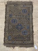 A small antique rug of geometric design 109cm x 65cm.