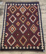 A Vintage kilim rug of all over geometric design (some splits) 275cm x 200cm.