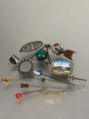A collection of six various white metal, silver and gilt metal brooches, two with enamel designs,