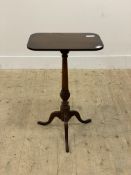 A George III mahogany pedestal table, the rectangular top with old split raised on a turned column