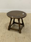 An 18th century style oak lamp table, the circular top raised on turned and block supports united by