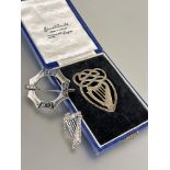 A silver celtic style harp brooch L x 4cm,  a white metal octagonal panel brooch with celtic