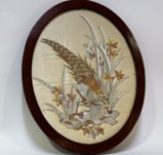 A decorative oval sewn work panel on silk of a silver pheasant, framed. (46cmx35cm)