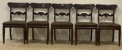 A set of five William IV mahogany dining chairs, the curved crest rail carved in low relief with