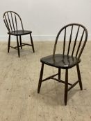 A pair of Vintage side chairs, each with hoop and spindle back over saddle seat, raised on turned