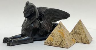 A cast metal bronze-patinated winged sphinx (h- 10cm, w- 18cm), together with a pair of travertine