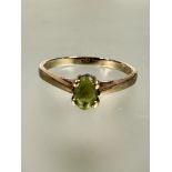 A 9ct gold oval cut peridot solitaire ring mounted in four claw setting S/T 2.3g