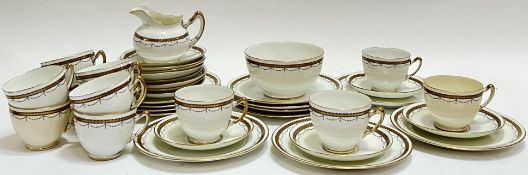 A Paragon China part tea service with Art Deco style gilt swag decoration and gilt rims comprising