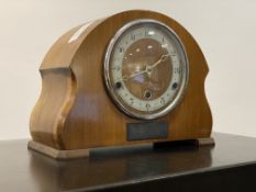 A 1930's walnut cased dome top mantel clock, the case with presentation plaque and enclosing a