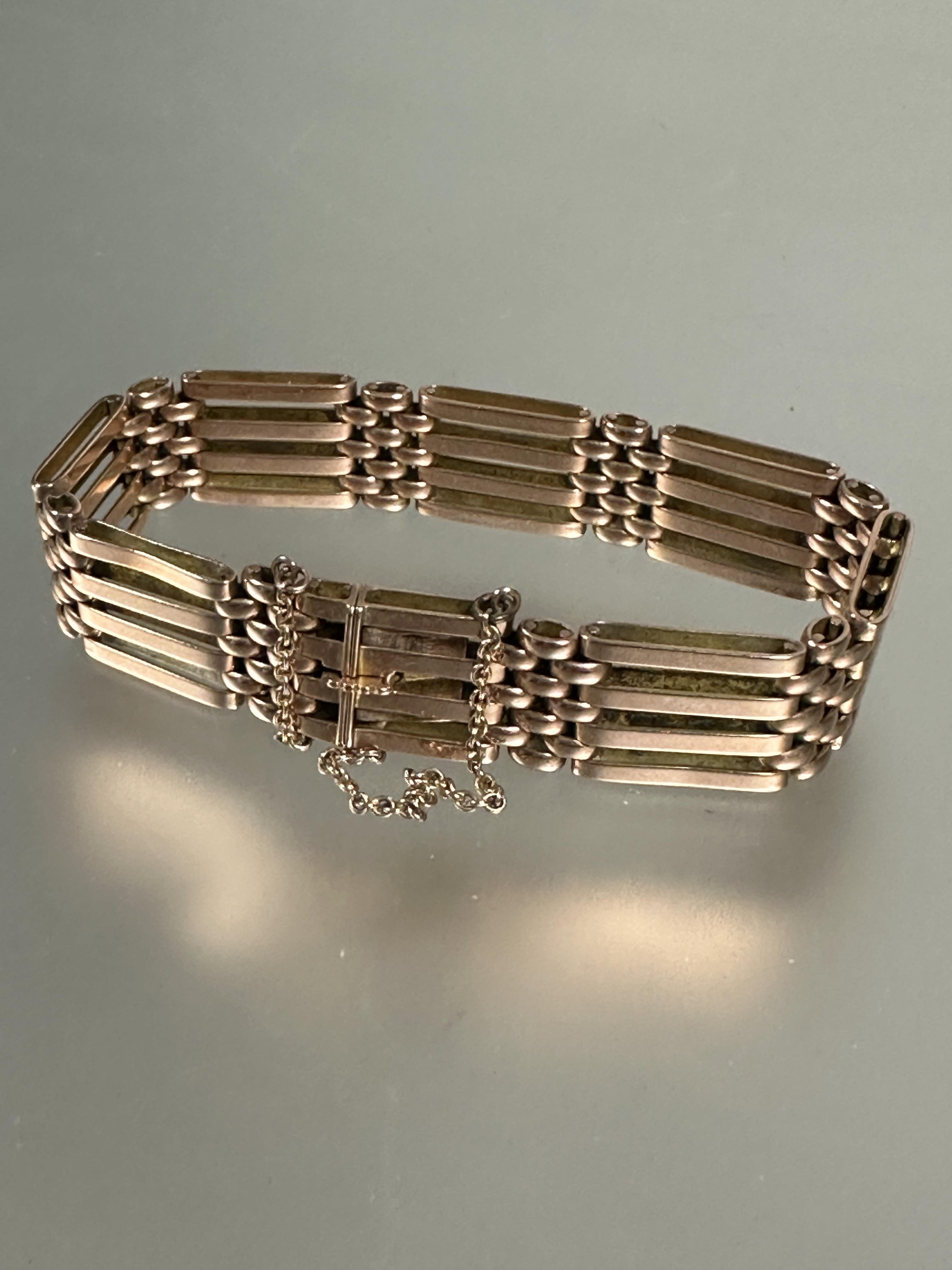 A 9ct rose gold gate link bracelet with clip fastening and safety chain no signs of damage or