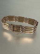 A 9ct rose gold gate link bracelet with clip fastening and safety chain no signs of damage or