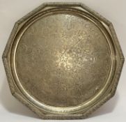 A large middle Eastern ten-sided signed white metal tray with scrolling chased decoration (signed