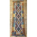 A Chobi kilim runner rug of geometric design 204cm x 65cm