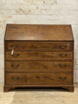 A George III mahogany bureau, the boxwood strung fall front opening to a well fitted interior, above