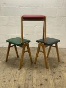 A set of three mid century beech and vinyl upholstered stools with 'A' frame supports, by