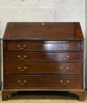 A George III mahogany bureau, late 18th century, the heavy fall front opening to a well fitted
