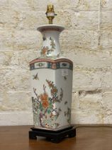 A polychrome enamelled Kangxi style squared lamp base, depicting flowers and butterflies, together