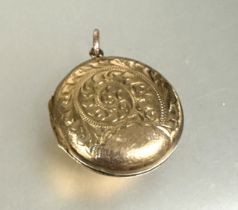 A 9ct gold back and front circular locket with engraved panel front D x 2.2cm