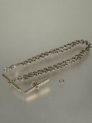 A yellow metal belcher link guard chain with gilt metal T bar, lobster claw fastening and extra T