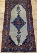 A 20th century Persian Serab rug, hand knotted, the beige field with pole medallion and bordered