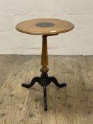 A Victorian walnut tripod table, the circular top raised on a turned column and triple splay