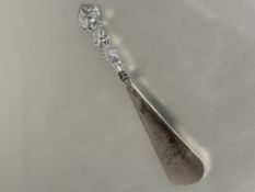 A Edwardian Birmingham silver handled steel shoe horn with chased bird and berry design shows no
