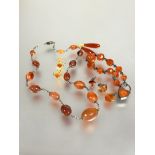 A collection of Edwardian carnelian jewellery to include and graduated bead necklace with white